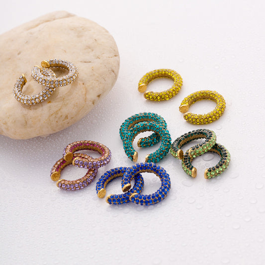 A vibrant collection of wholesale stainless steel earrings from JR Fashion Accessories, featuring various styles including hoops, studs, and dangles in multiple colors.