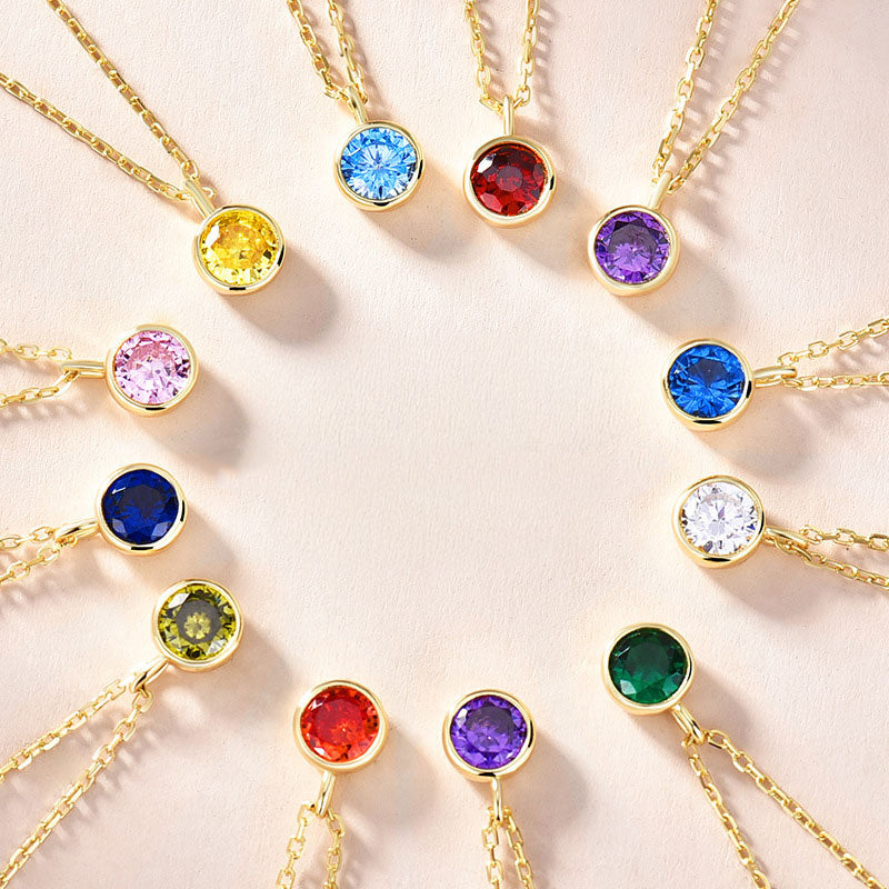 A vibrant collection of 925 sterling silver zodiac birthstone pendant necklaces, displaying a variety of colorful zircon gemstones.