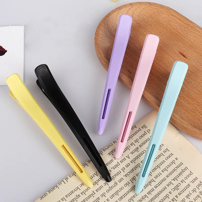 A set of five colorful salon duck beak hair clips arranged neatly on a white background, showcasing the different color options available.