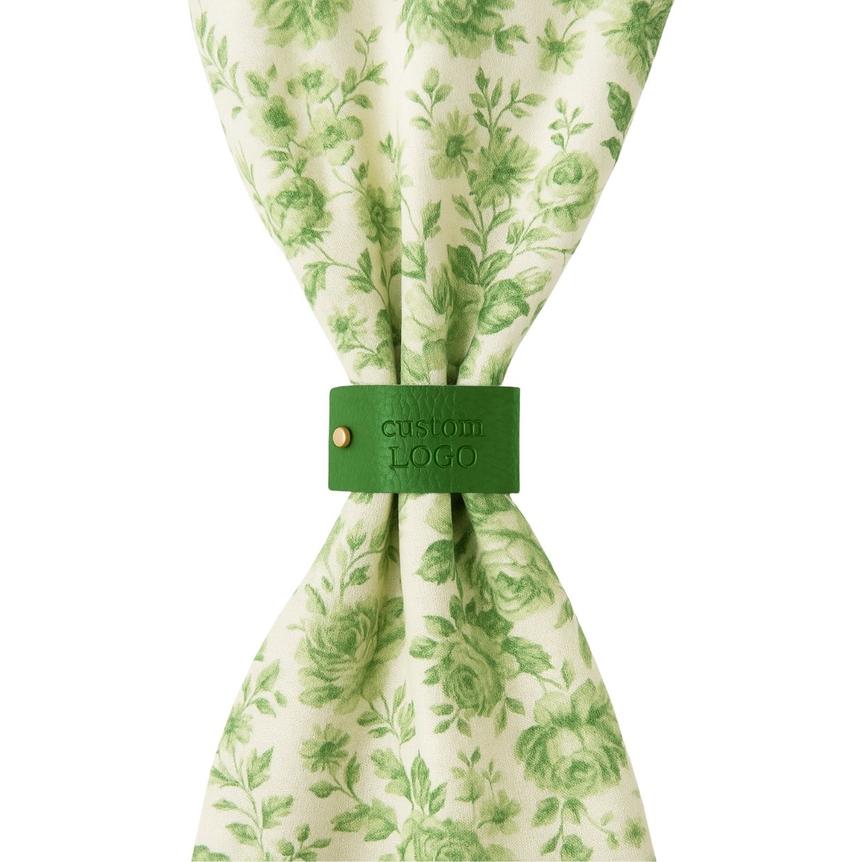 A neatly folded white napkin held together by a custom brown leather napkin ring, showcasing a sophisticated table setting for events or hotels.