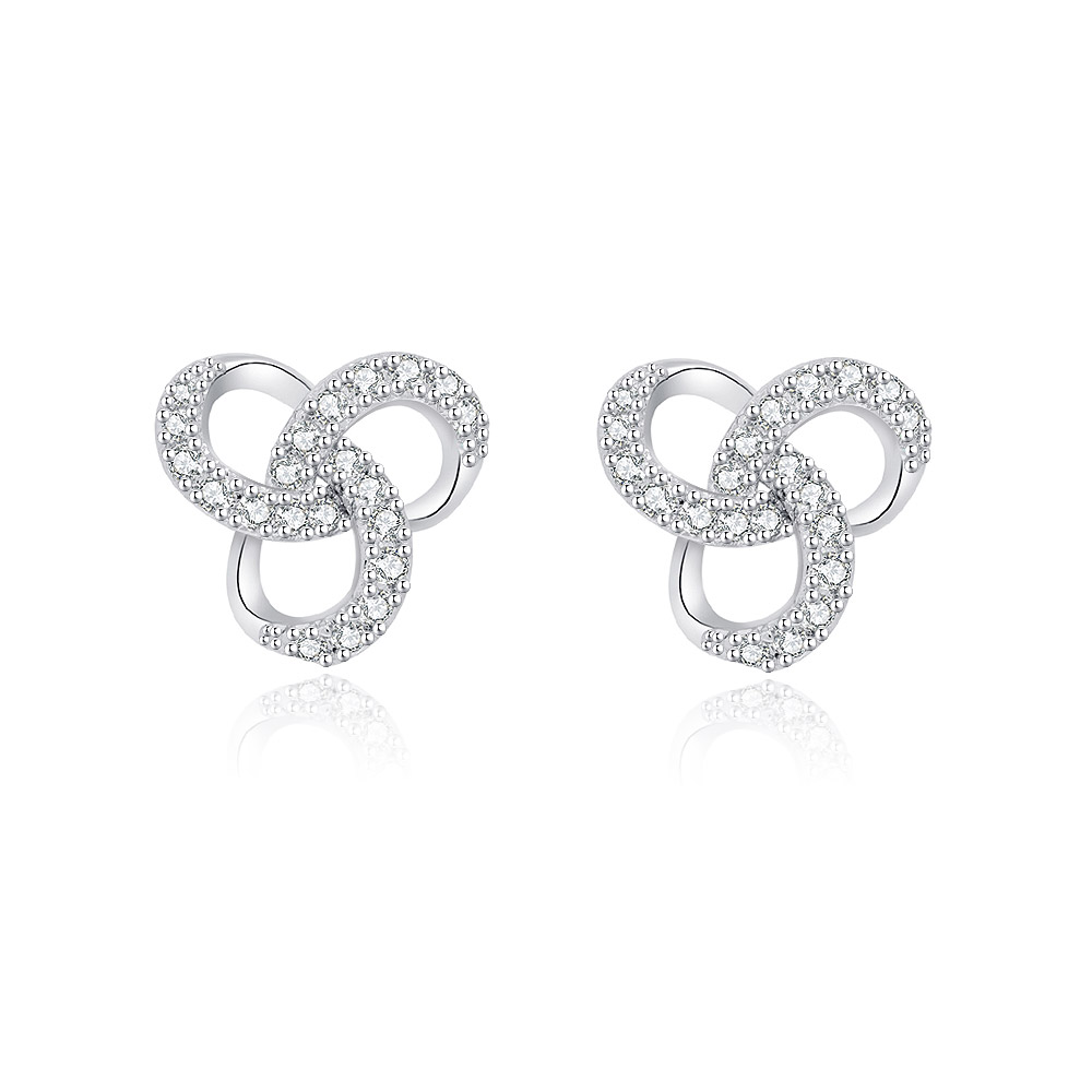 A pair of small twisted love knot stud earrings, crafted from rhodium-plated brass and sparkling with white cubic zirconia stones, displayed on a clean white background.