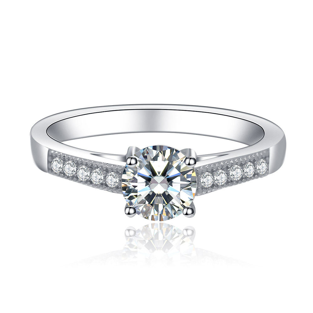 A vintage-style 925 sterling silver engagement ring featuring a prominent round clear cubic zirconia centerpiece with detailed side accents.