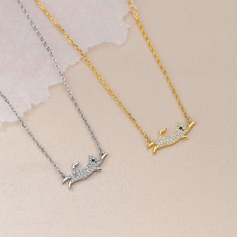 A pair of 925 sterling silver dog pendant necklaces, one in a silver finish and one in a gold finish, both adorned with sparkling cubic zirconia stones.