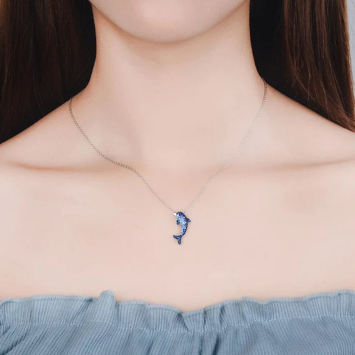 A close-up of the 925 Sterling Silver Dolphin Pendant Necklace, showcasing the intricate blue and clear zircon stones on a silver chain.