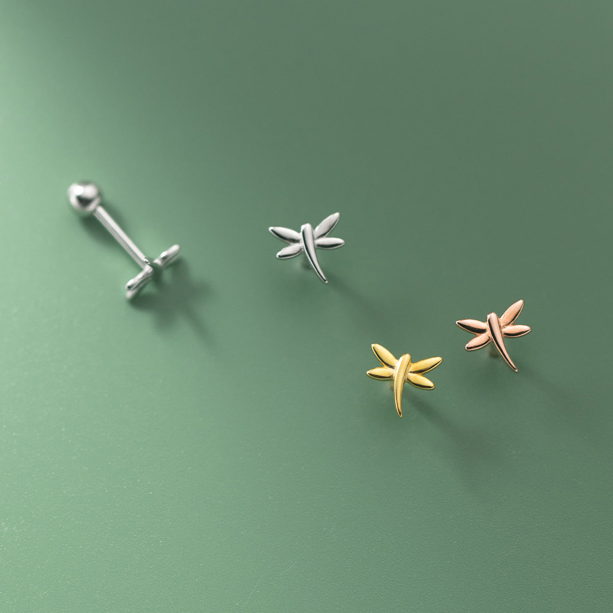 A collection of 925 sterling silver mini dragonfly stud earrings shown in silver, gold, and rose gold finishes, with a secure screw-back closure.