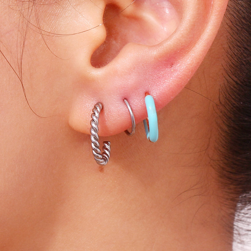 Close-up of a woman's ear wearing the stylish illusion stainless steel spiral twist earrings, showcasing their unique design and comfortable fit.