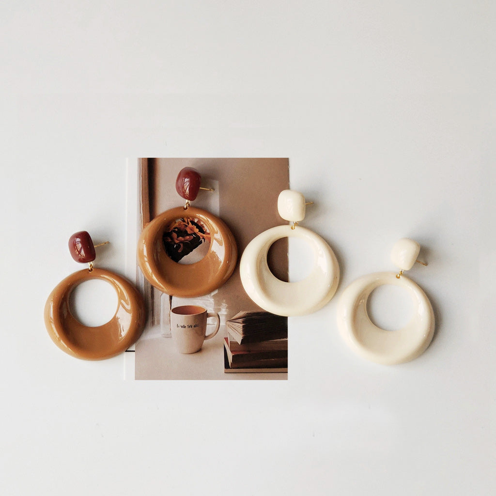 A promotional display of three pairs of vintage modern geometric acrylic hoop and drop earrings from the 5-pair set.