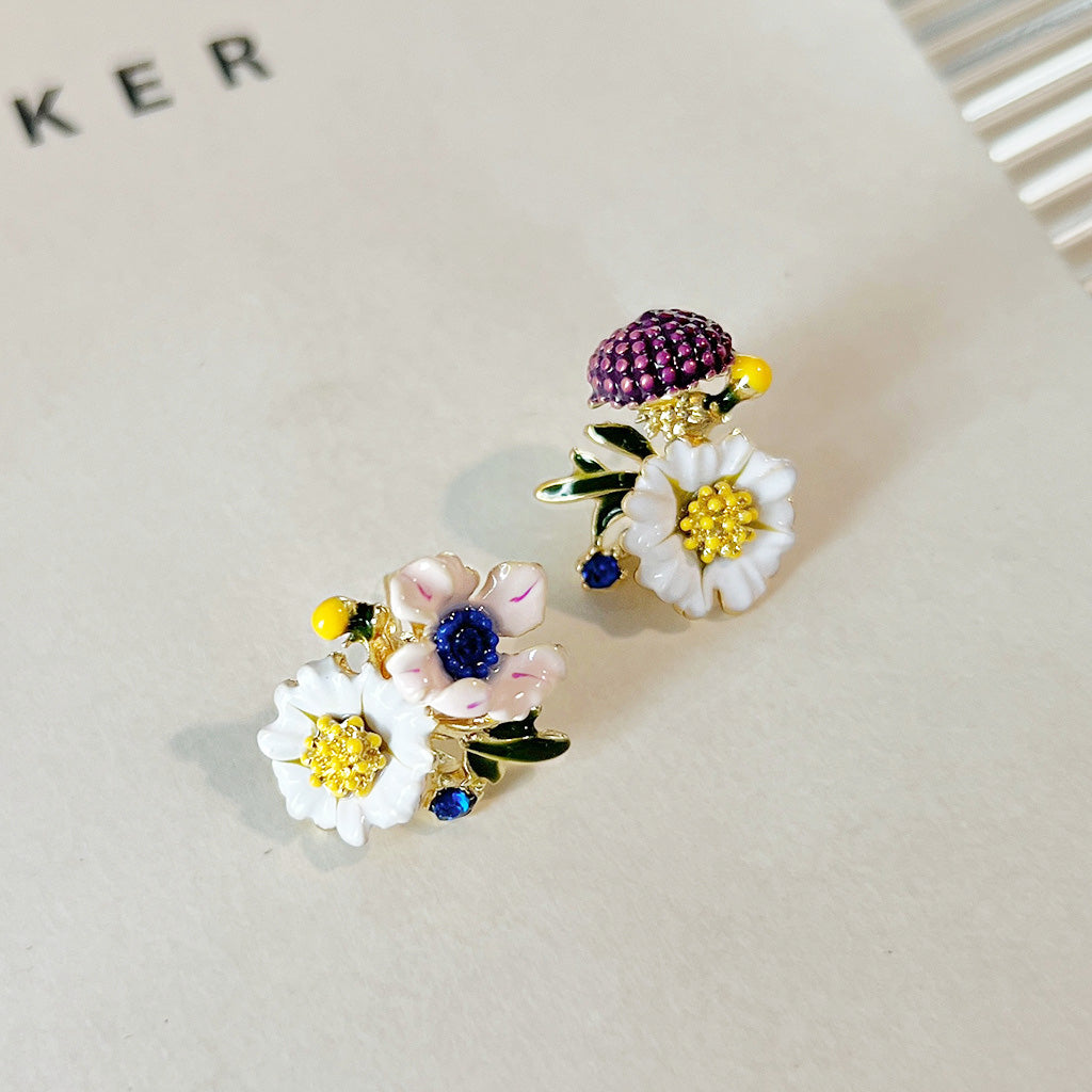 A set of 5 pairs of 14k gold-plated stud earrings, featuring hand-painted enamel flowers with white petals, gold accents, and colorful centers.