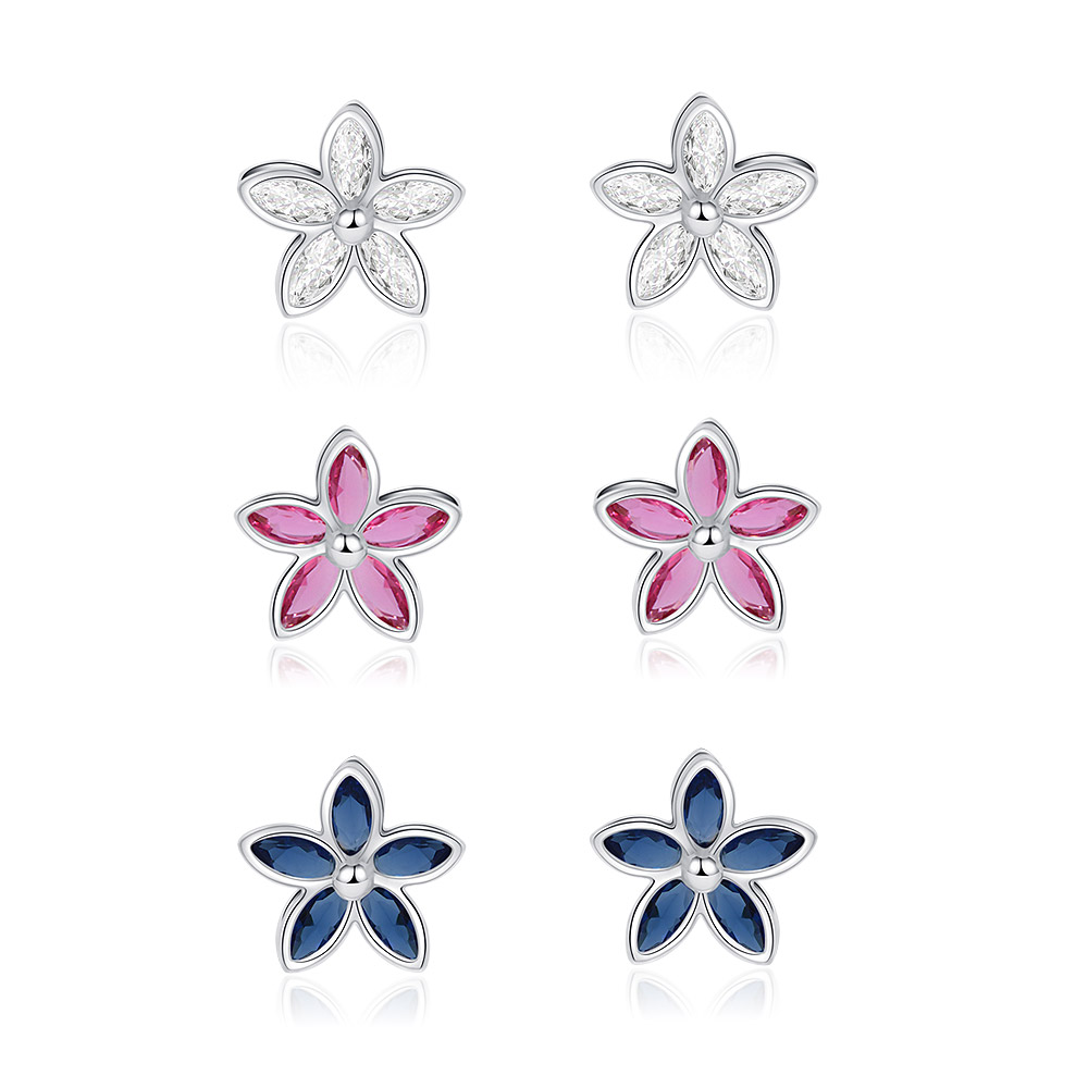 A set of three pairs of flower-shaped stud earrings with rhodium plating, featuring clear, light rose, and Montana blue cubic zirconia stones.