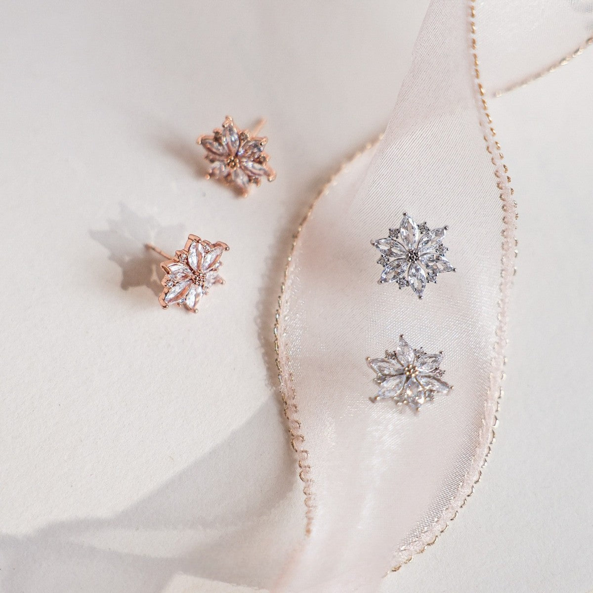 A set of four pairs of 925 Sterling Silver Gold Plated Sparkling Cubic Zirconia Earrings in flower shapes, displayed in both rose gold and silver tones.