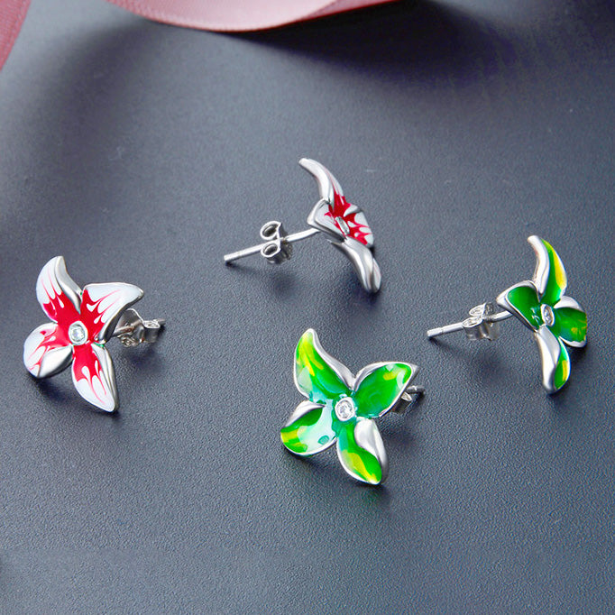 A collection of 925 sterling silver 3D flower stud earrings with vibrant red and green enamel detailing, displayed on a dark background.