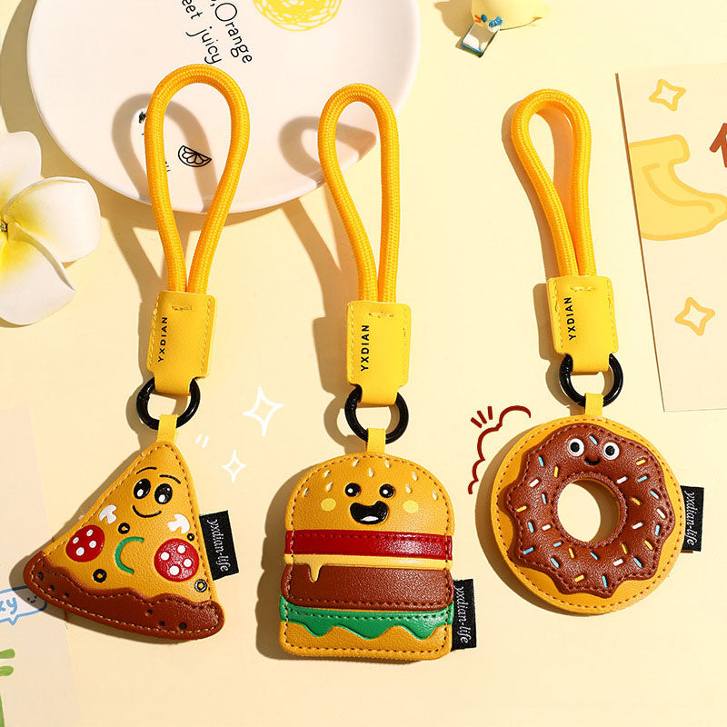 A collection of three creative food-themed PU leather keychains: a smiling pizza slice, a cheerful hamburger, and a cute donut, perfect as car pendants or bag charms.
