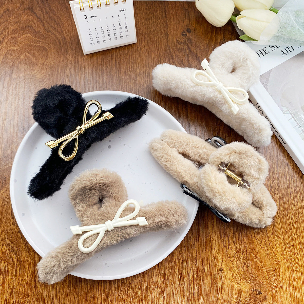 A collection of women's winter fluffy plush claw hair clips in various colors including black, brown, and khaki.