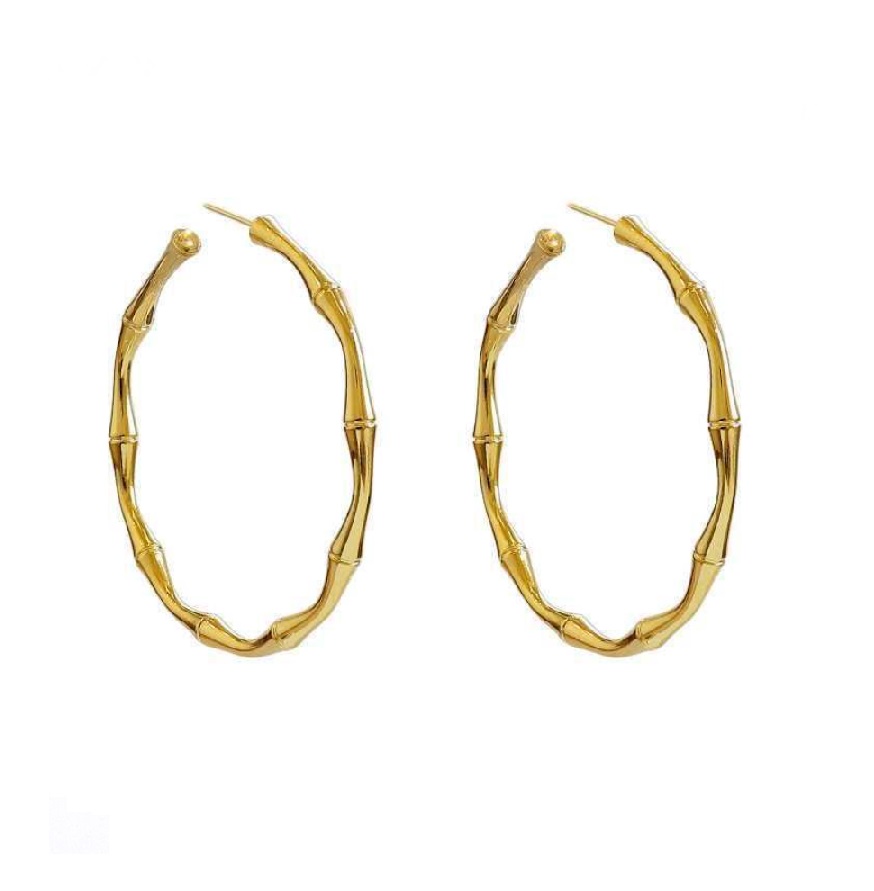 Close-up of gold bamboo-textured medium hoop earrings (JRE-109), highlighting the intricate bamboo-like segments and polished gold plating.
