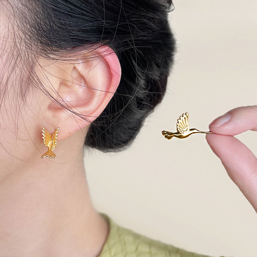 A detailed close-up of the wholesale brass matte gold 3D bird stud earrings, showcasing the intricate design and sophisticated matte texture.