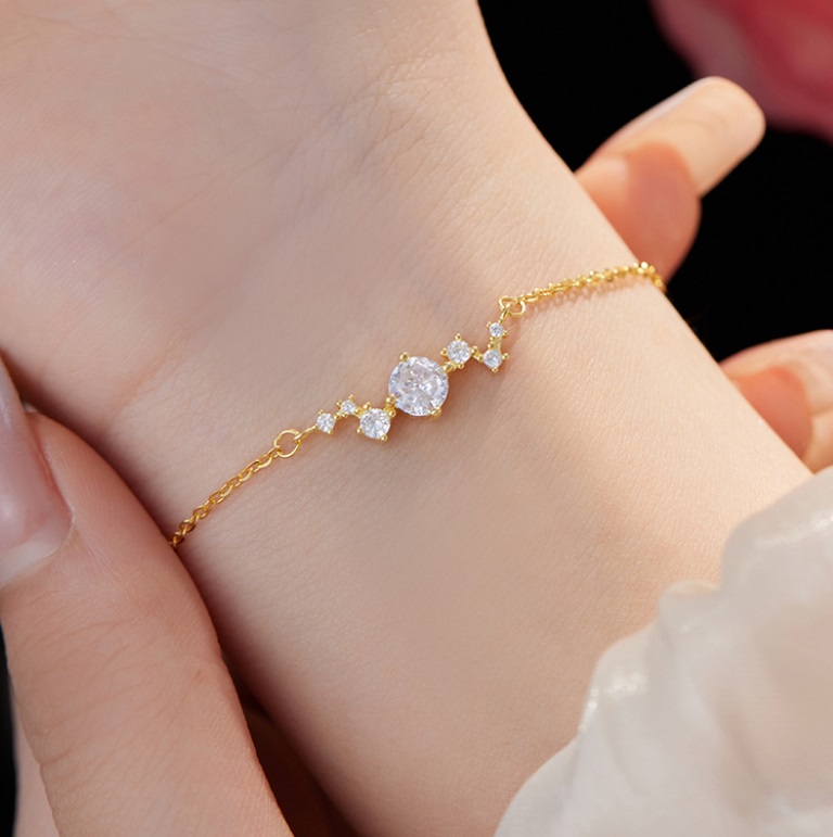 Close-up view of the 925 Sterling Silver Glitzy Bracelet in gold plating, highlighting the intricate details and sparkling white cubic zirconia stones.