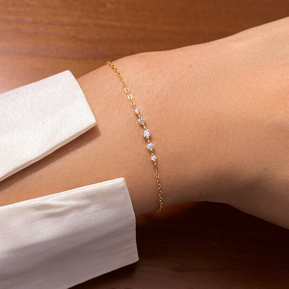 A model wearing the Exquisite Pavé Silver Bracelet, showcasing its gold-tone finish and shimmering pavé gemstones on the wrist.
