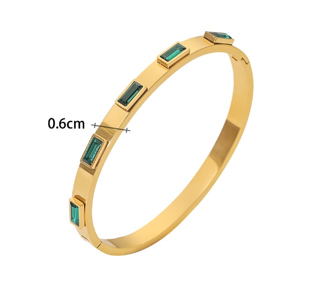 Close-up of the OEM Stainless Steel Bangle JRG-005, featuring a polished gold finish and inlaid with rectangular green gemstones.