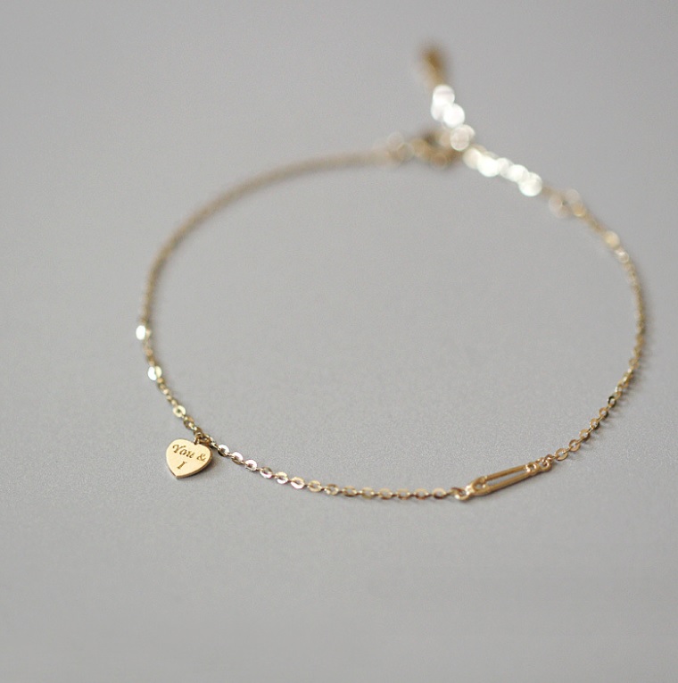 Close-up of the 925 Sterling Silver Heart Gold Plated Bracelet, highlighting the detailed heart charm with 'You & I' engraving and its polished gold finish.