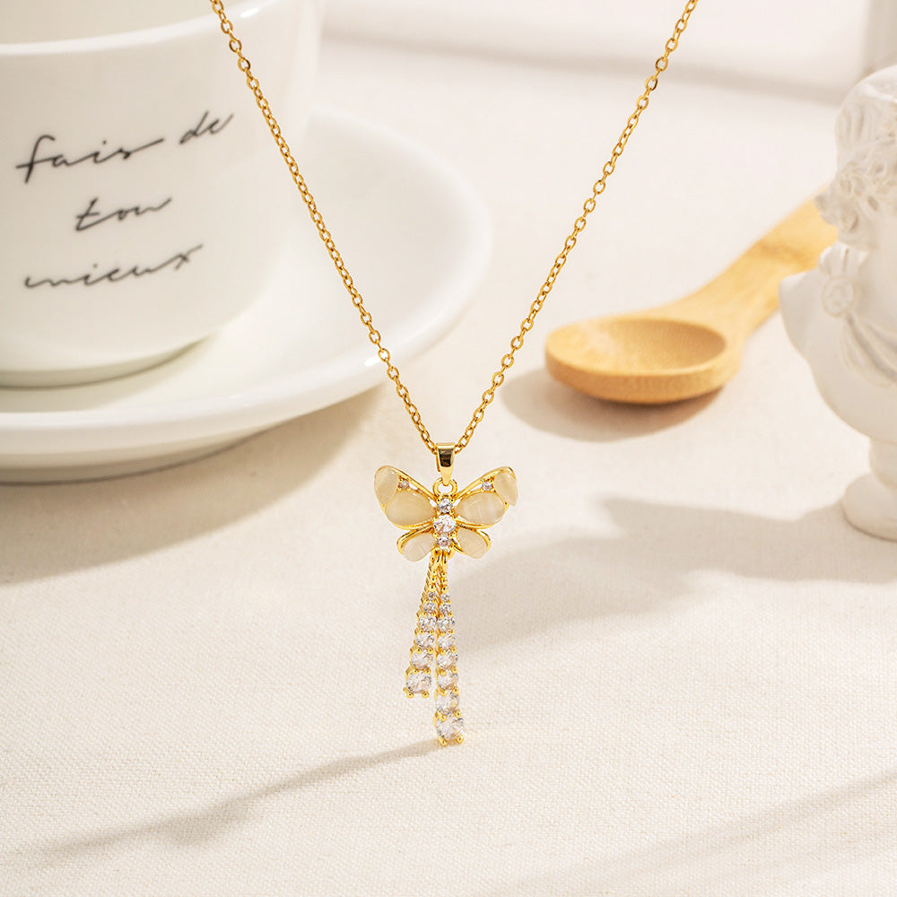 A stunning gold PVD plated stainless steel necklace from a set of five, featuring a delicate butterfly pendant adorned with clear CZ and zircon stones.