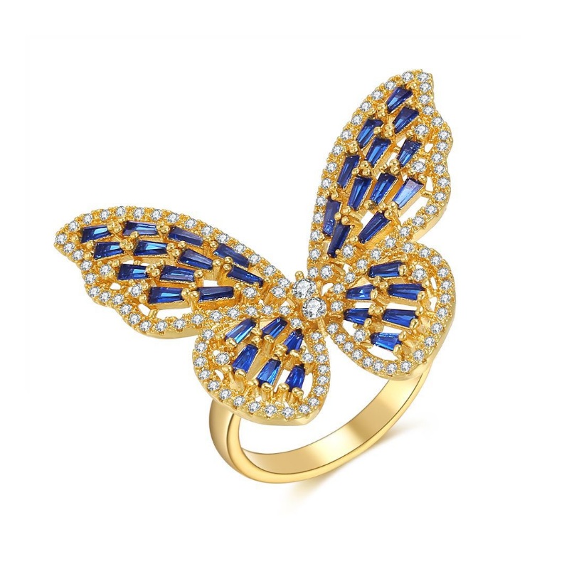 Adjustable statement butterfly ring in gold plating, featuring intricate blue and clear cubic zirconia stones that form the delicate wings.