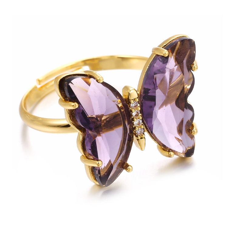 Adjustable gold butterfly ring featuring vibrant purple gemstone wings and sparkling cubic zirconia accents.