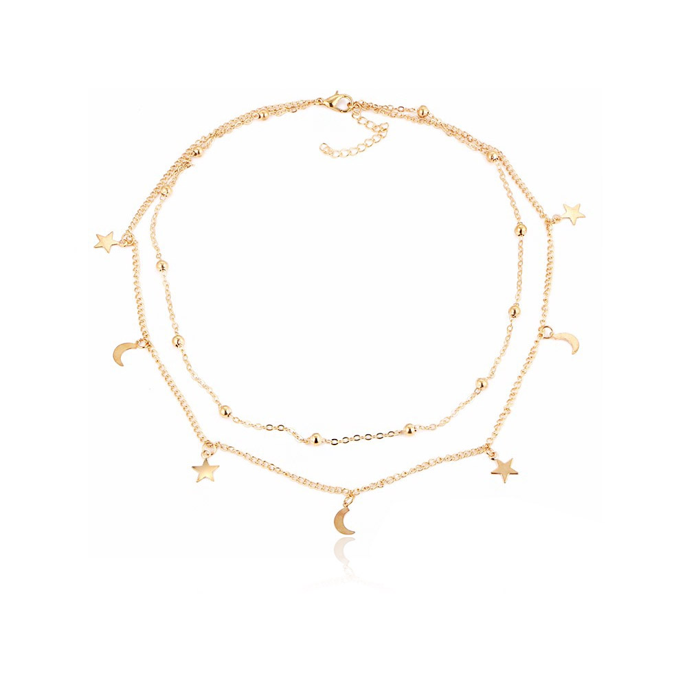 A delicate double-layered gold-plated necklace featuring minimalist star and moon charms on a white background.