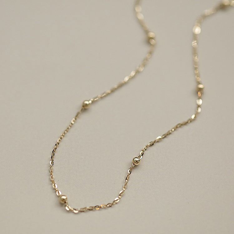 A delicate 925 sterling silver bead chain charm bracelet with a gold finish, shown on a clean white background.