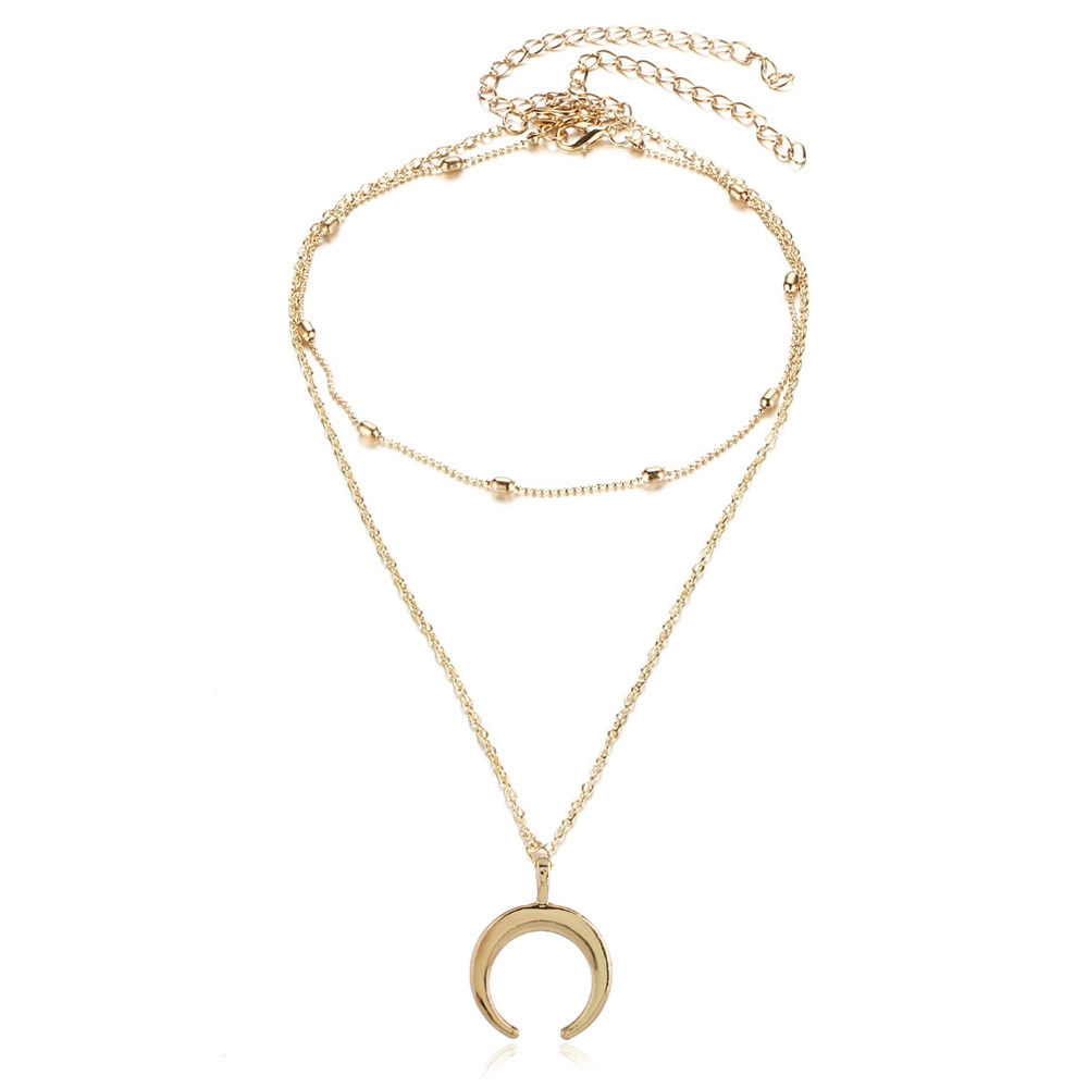A close-up view of the Gold Crescent Pendant Layering Chain Choker, showcasing its double-chain design and polished gold finish.