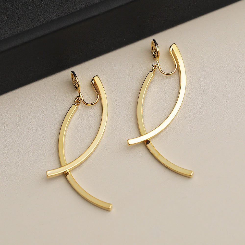 A pair of gold-plated fish shape wire cross non-pierced clip earrings with a unique curved design, shown on a clean white background.