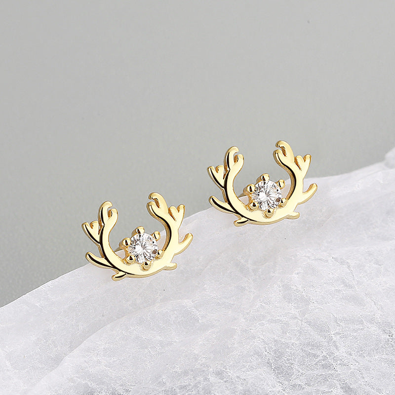 A close-up of the 925 sterling silver gold-plated elk antler stud earrings, showcasing the intricate design and sparkling zircon gemstones.