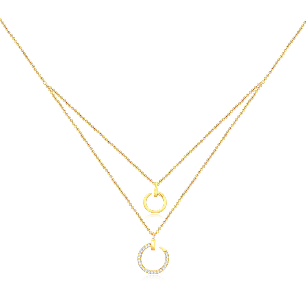Wholesale layered necklace with two gold chains and circular pendants, one plain and one with cubic zirconia stones, on a white background.