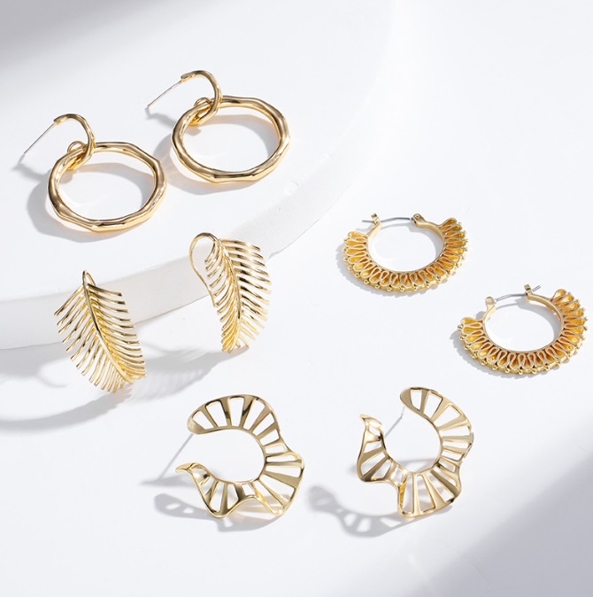 A diverse collection of 18K gold-plated earrings by JR Fashion Accessories, showcasing various elegant designs for wholesale.