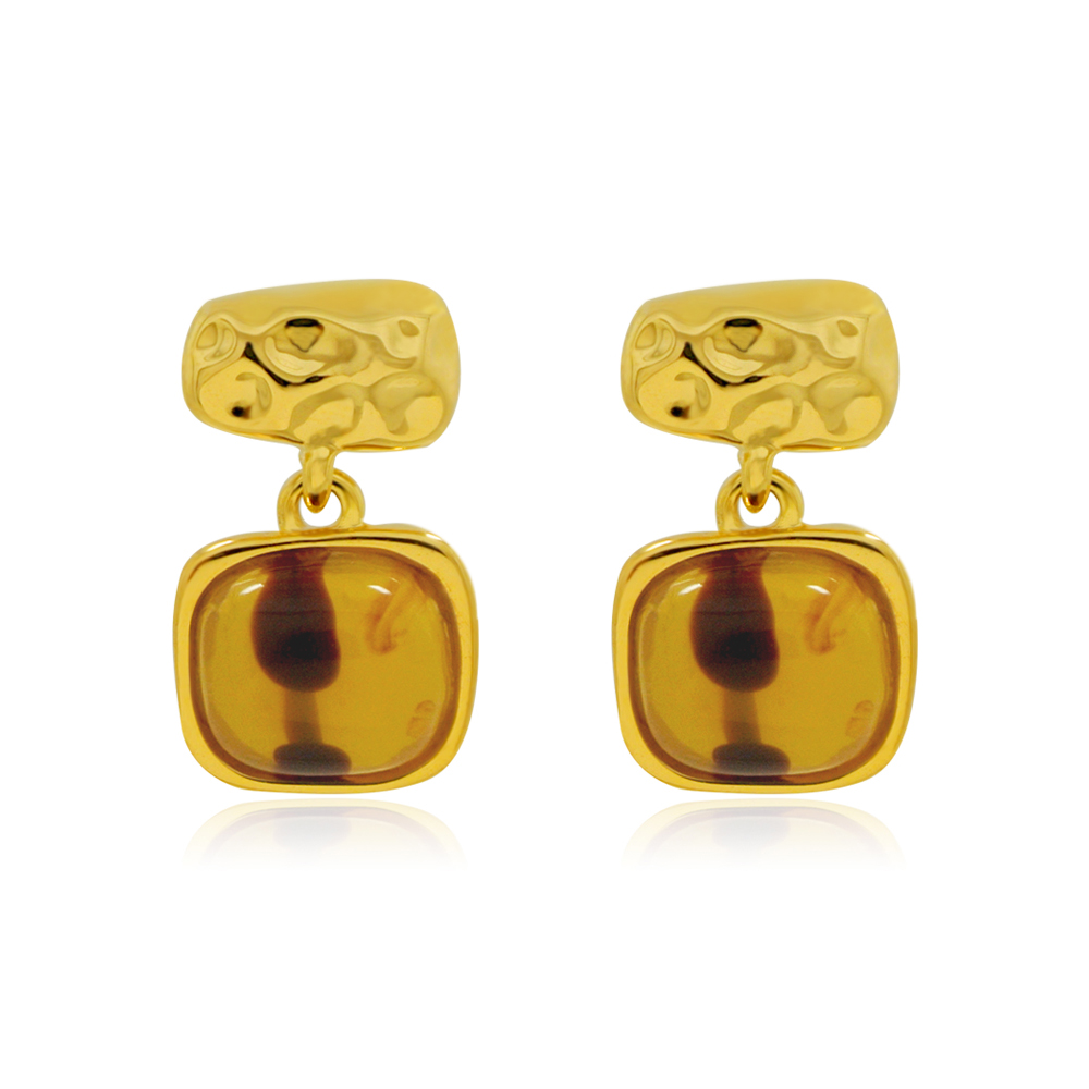A close-up of the Tiger Eye Resin Hammer Drop Earrings, showcasing the gold-plated brass setting and the brownish amber-colored resin stone.