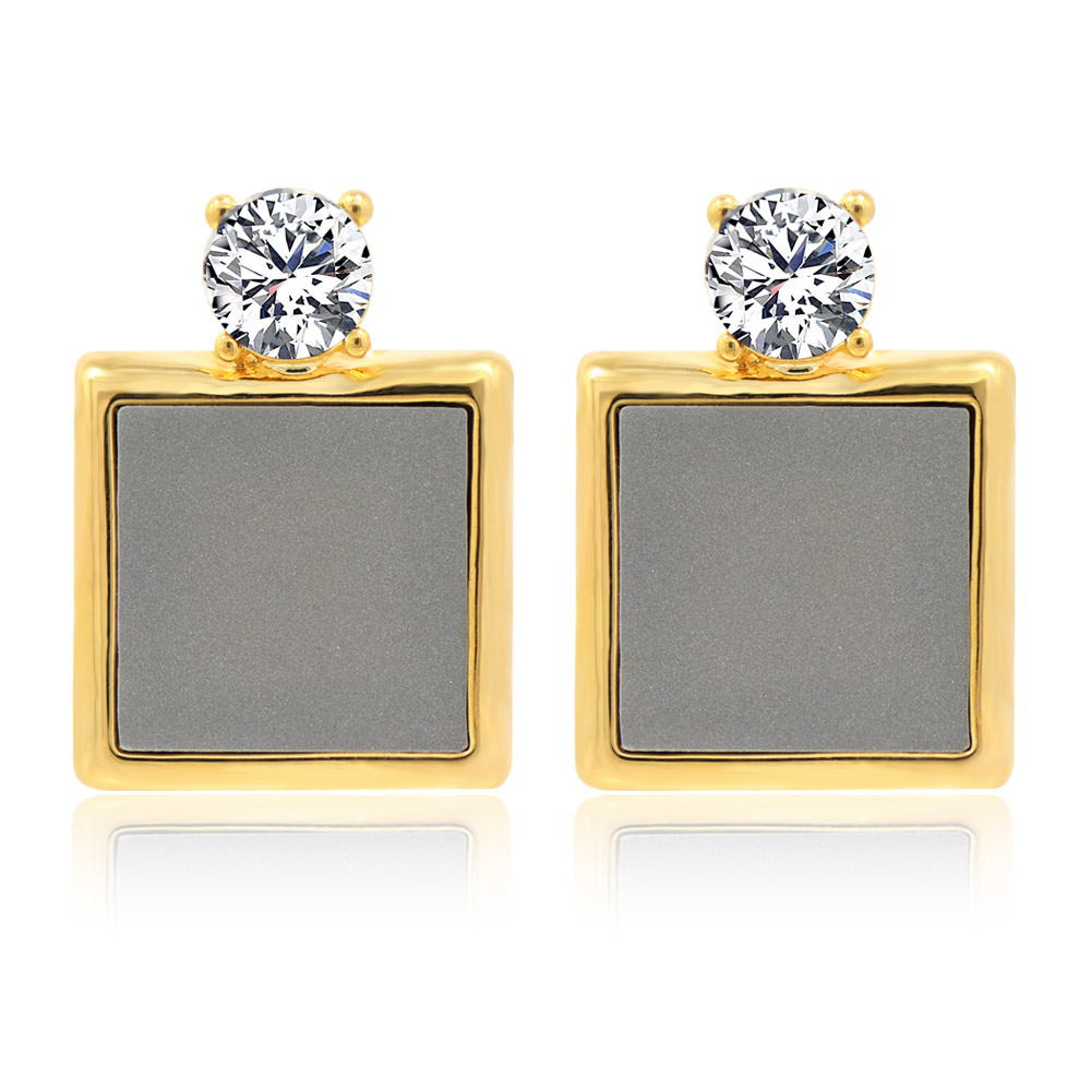 A close-up of the Square Geometry Acrylic Drop Earrings, featuring a gold-plated square stud with a grey acrylic insert and a sparkling white Czech crystal.
