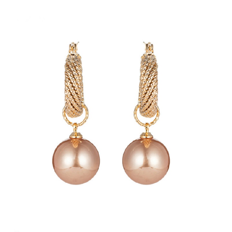 A pair of Pearl Vintage Gold Huggie Earrings (JRE-119) featuring gold-plated brass hoops and large, light brown pearl caps, displayed on a clean white background.