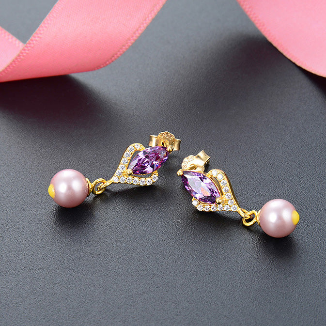 A close-up of the 925 sterling silver earrings, showcasing the brilliant purple crystal zircon and the lustrous single pearl drop on a gold-tone setting.