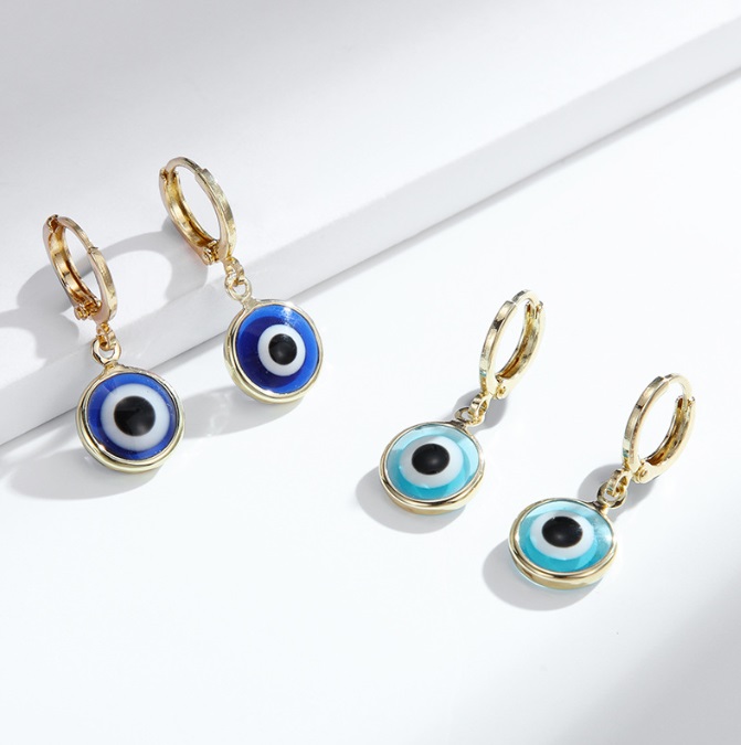 A pair of Small Hoop Evil Eyes Earrings in gold-plated brass, showcasing the intricate enamel and crystal design.