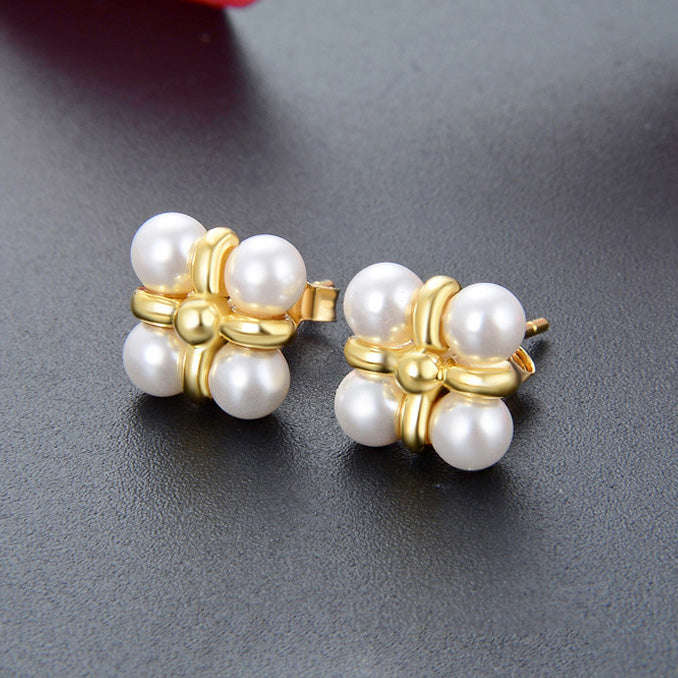 A close-up of the 925 sterling silver gold-plated stud earrings, showcasing the four lustrous pearls arranged in a delicate flower pattern.