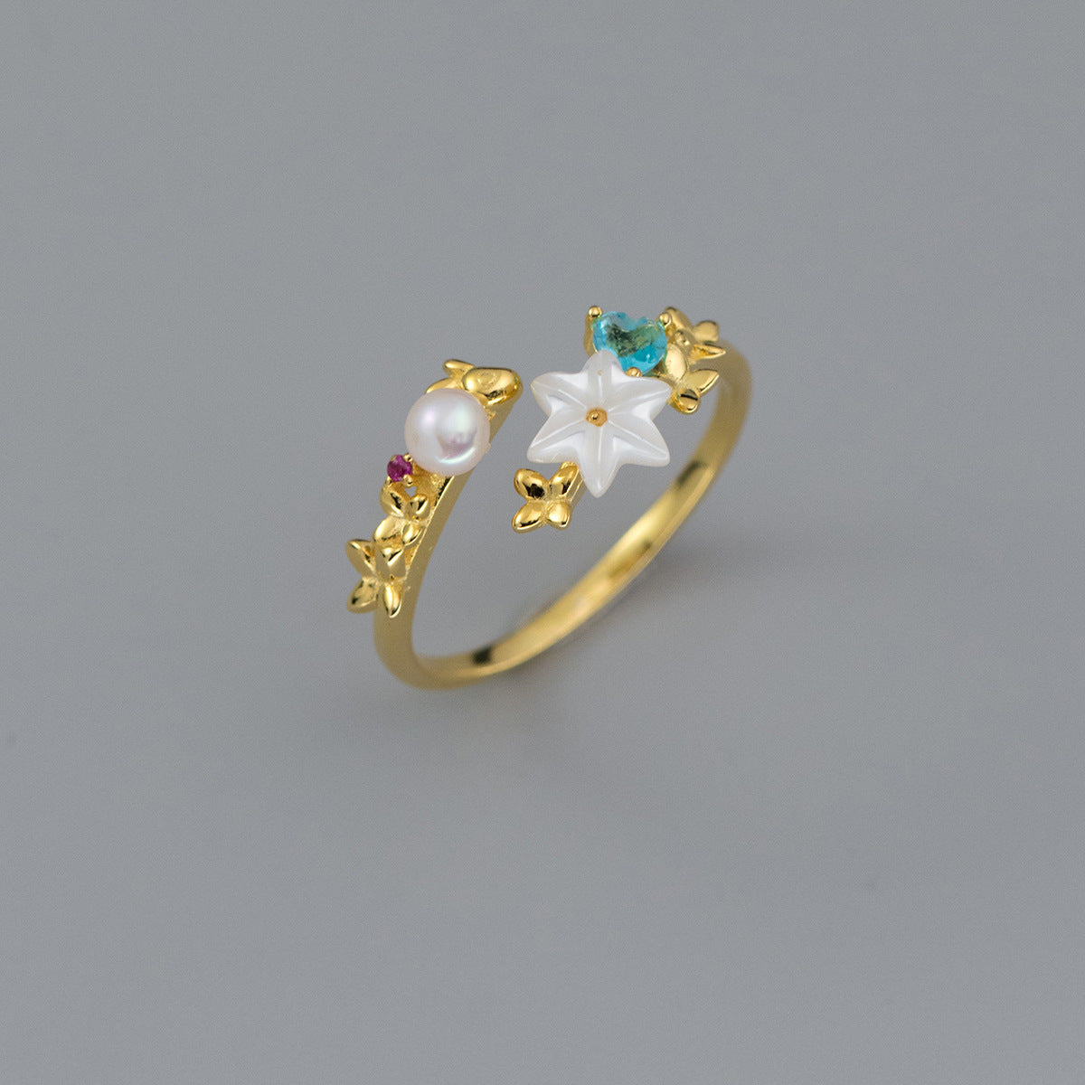 A gold-plated 925 sterling silver ring from a set of five, featuring an elegant pearl and floral gemstone design, representing a wholesale jewelry collection.