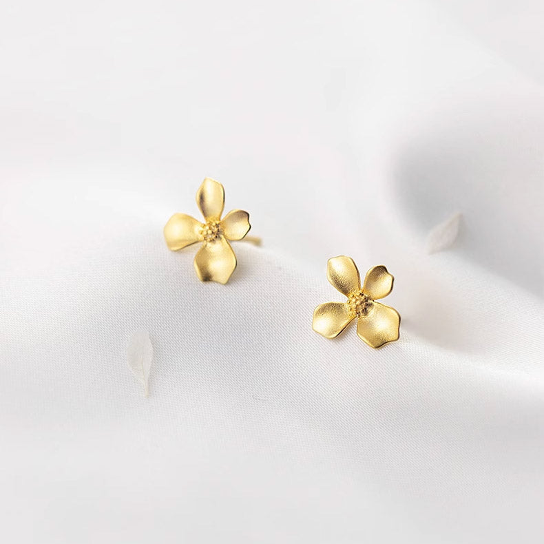 A pair of 925 sterling silver small flower earrings with gold plating, shown on a clean white background.