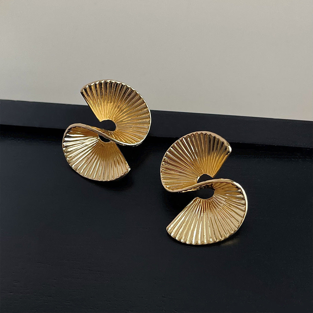 A pair of minimalist irregular geometric earrings in 14K gold plated brass, featuring a unique fan-shaped spiral design.