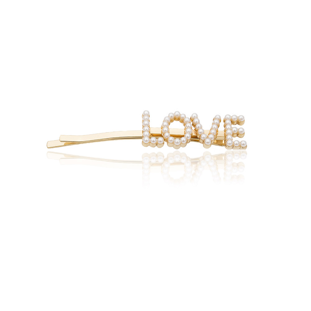 Customizable gold hair clip featuring the word 'LOVE' encrusted with elegant pearls, showcasing the personalized accessory options.