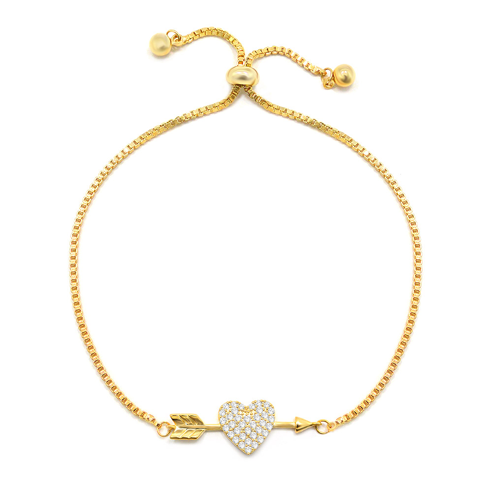 A detailed view of the gold-plated Heart Arrow Bracelet, highlighting the intricate heart and arrow charm embellished with brilliant white cubic zirconia stones on a delicate chain.