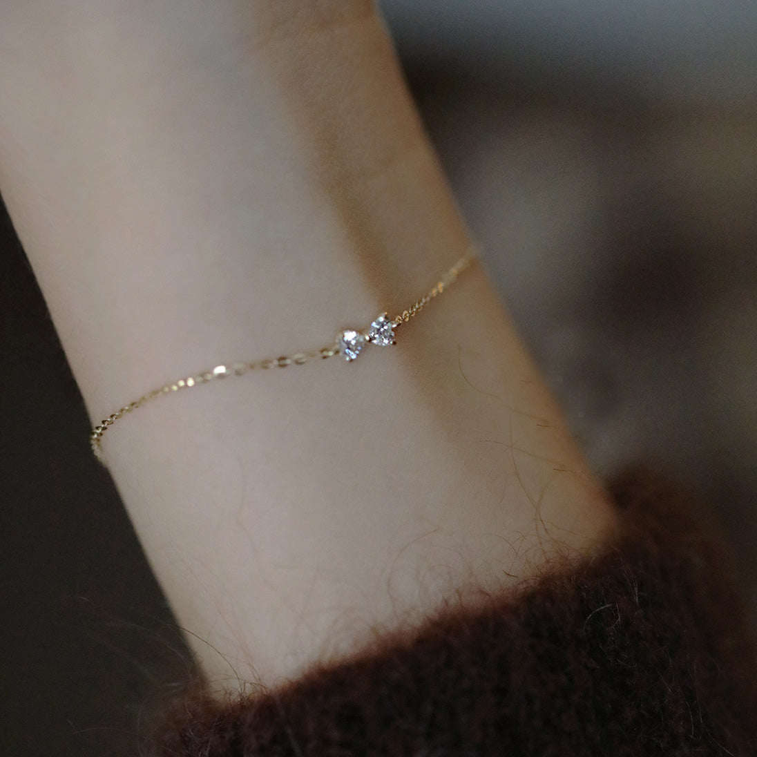 A close-up of the S925 gold elegant bowknot cable chain bracelet worn on a wrist, highlighting its delicate design and sterling silver material.