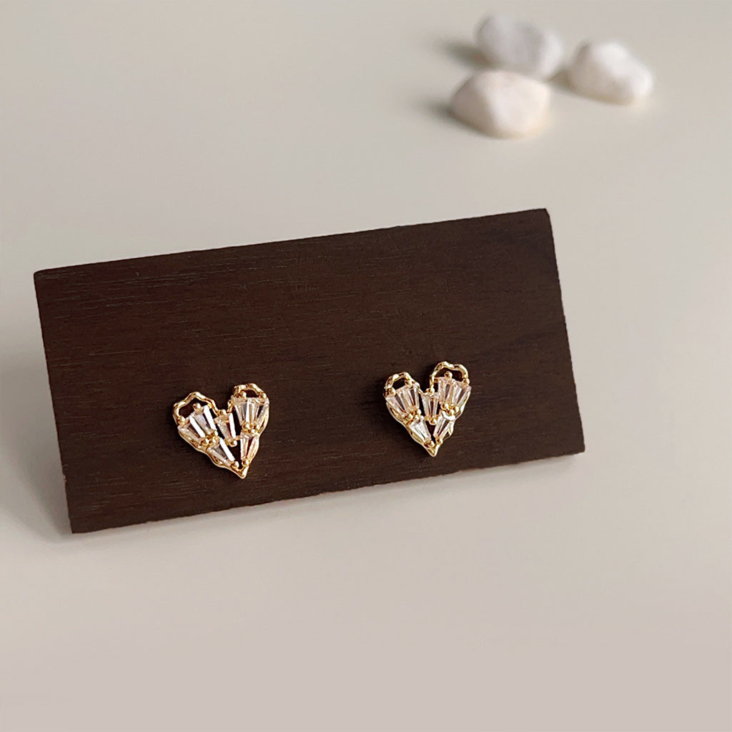A set of five pairs of fashion gold-plated heart-shaped stud earrings with sparkling clear zircon stones, displayed on a clean white background.