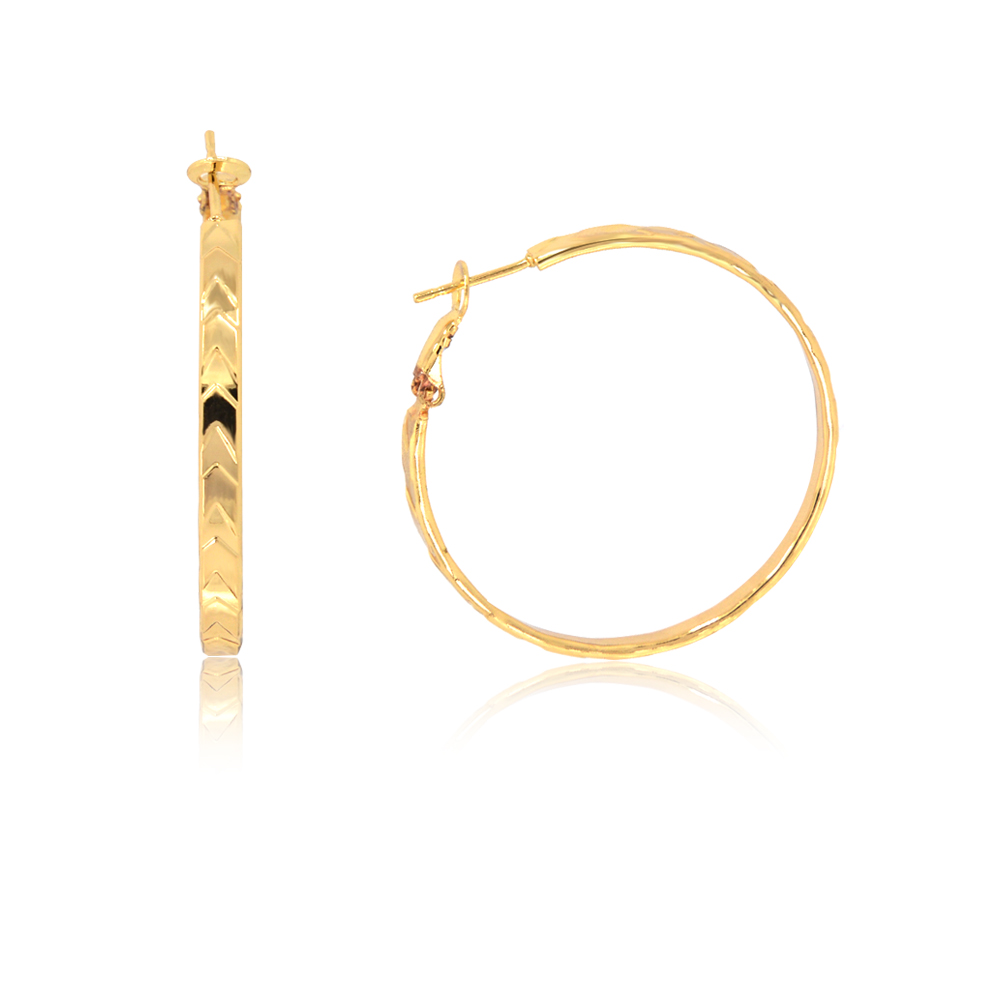 Close-up of Diamond-cut Bold Round Hoop Earrings showcasing the intricate chevron-like texture on the gold-plated surface.