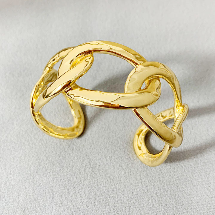 A detailed view of the Brass Flat Curb Chain Style Cuff Bangle Bracelet, showcasing its intricate, interconnected design and brilliant gold finish.