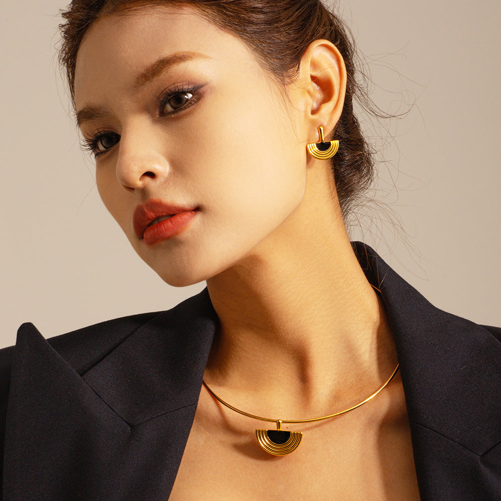 A model showcasing the elegant 18K gold plated Egyptian fan-shaped pendant necklace and matching earrings, highlighting its sophisticated design.