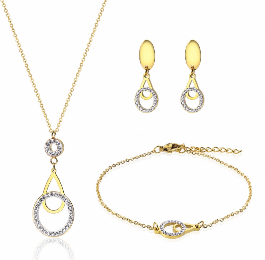A stunning gold jewelry set from JR Fashion Accessories, featuring a matching necklace, earrings, and bracelet adorned with sparkling clear stones, available for wholesale.